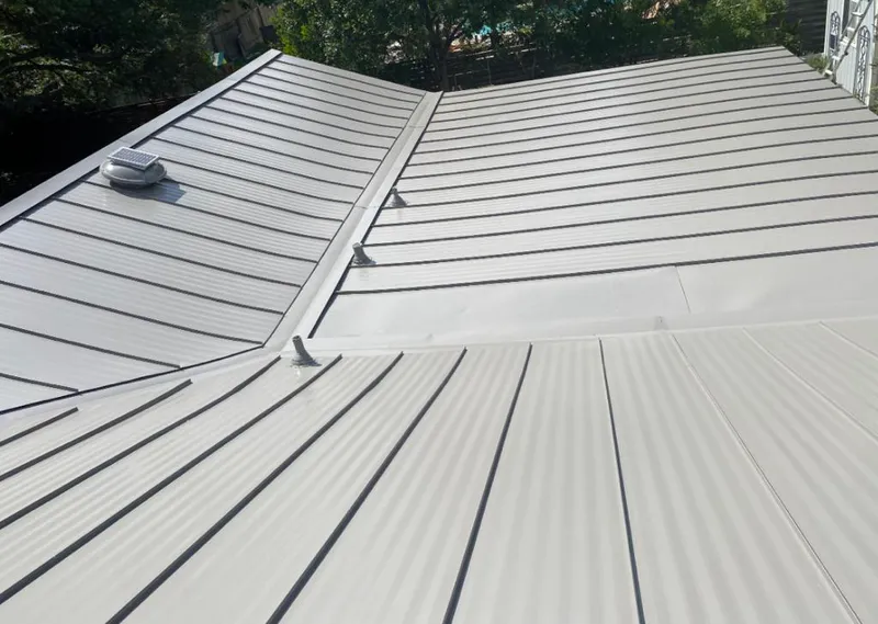Solar attic fan installed on a metal roof for Roof Ventilation in Woodfield